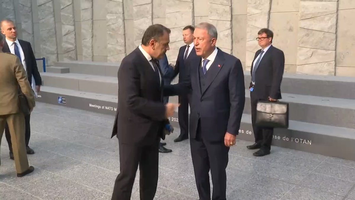 Greek and Turkish defence ministers at NATO defence ministers meeting