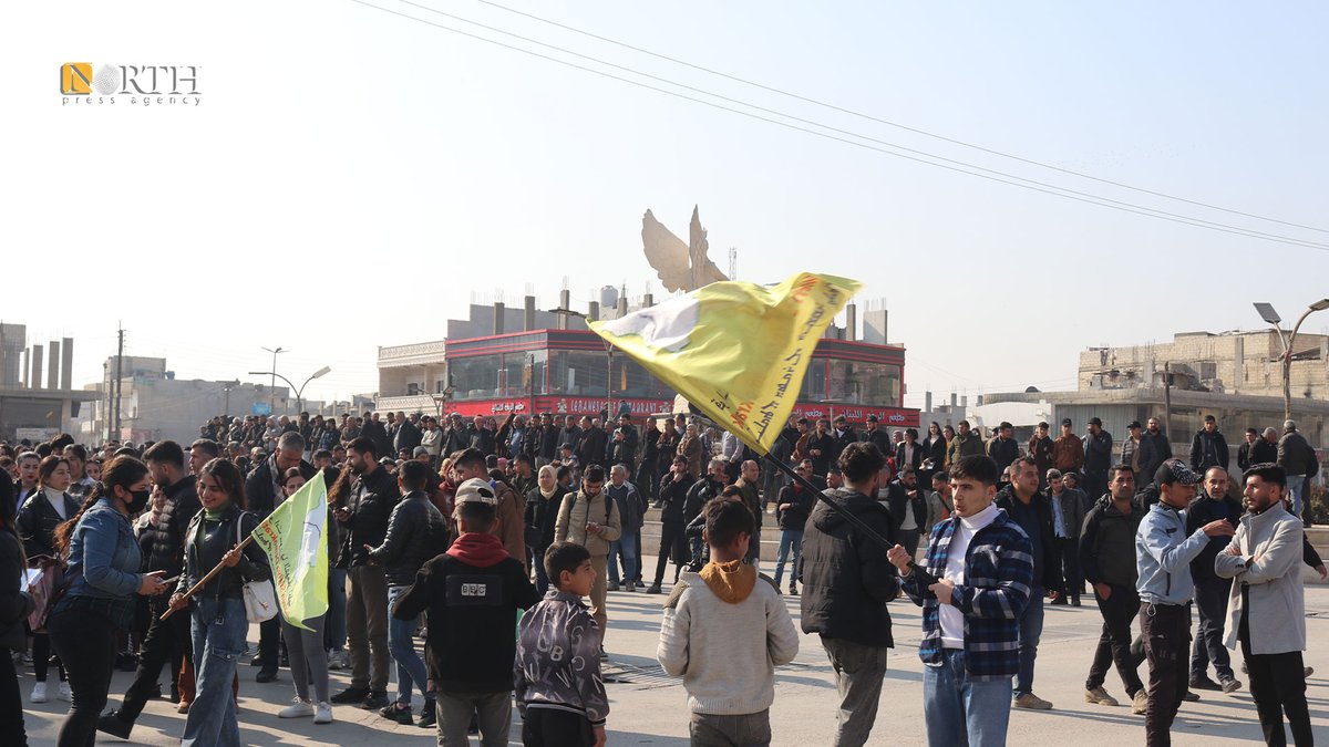 People in the city of Kobani, northern Syria, condemn Turkish airstrikes against a civilian convoy near Tishrin Dam